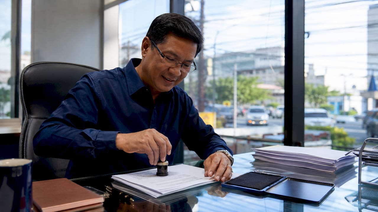Notary stamping employment contract documents in office
