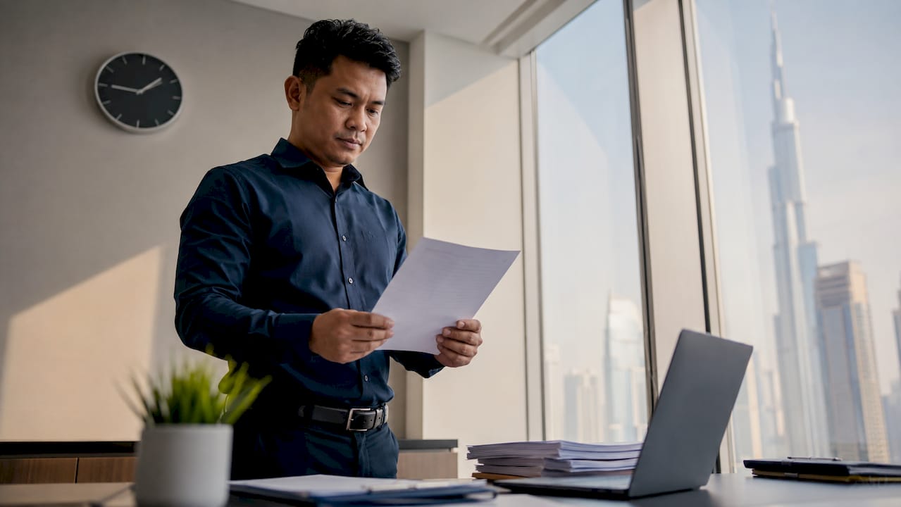 Filipino man reviewing affidavit at UAE service center