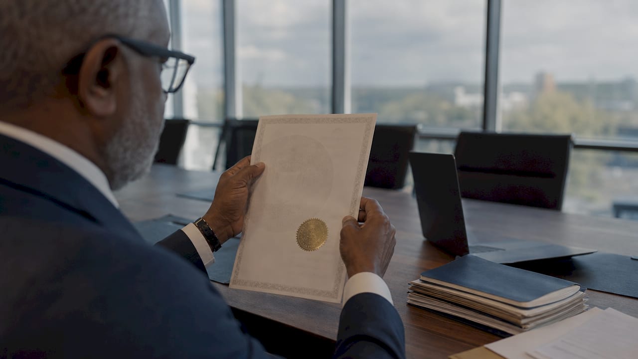 Hands inspecting paper apostille closely