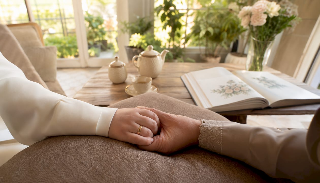 Close-up of hands holding on prayer rug