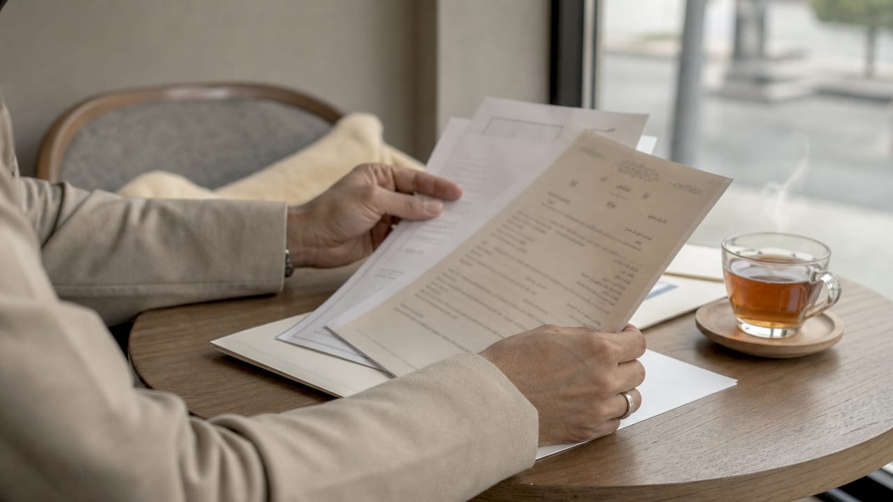 Hands examining UAE civil marriage documents