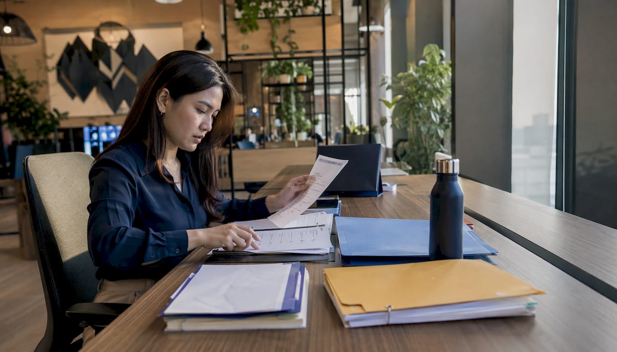 Filipino expat organizing documents at home