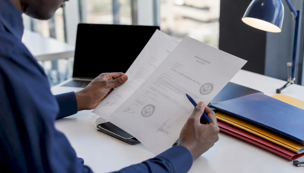 Close-up of hands checking document name mismatches