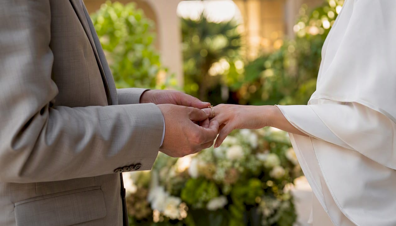 Hands exchanging rings in Abu Dhabi marriage ceremony