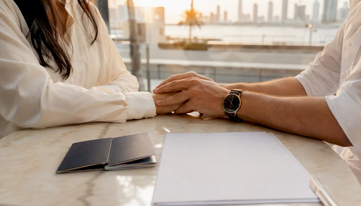 Couple hands with passports and marriage papers
