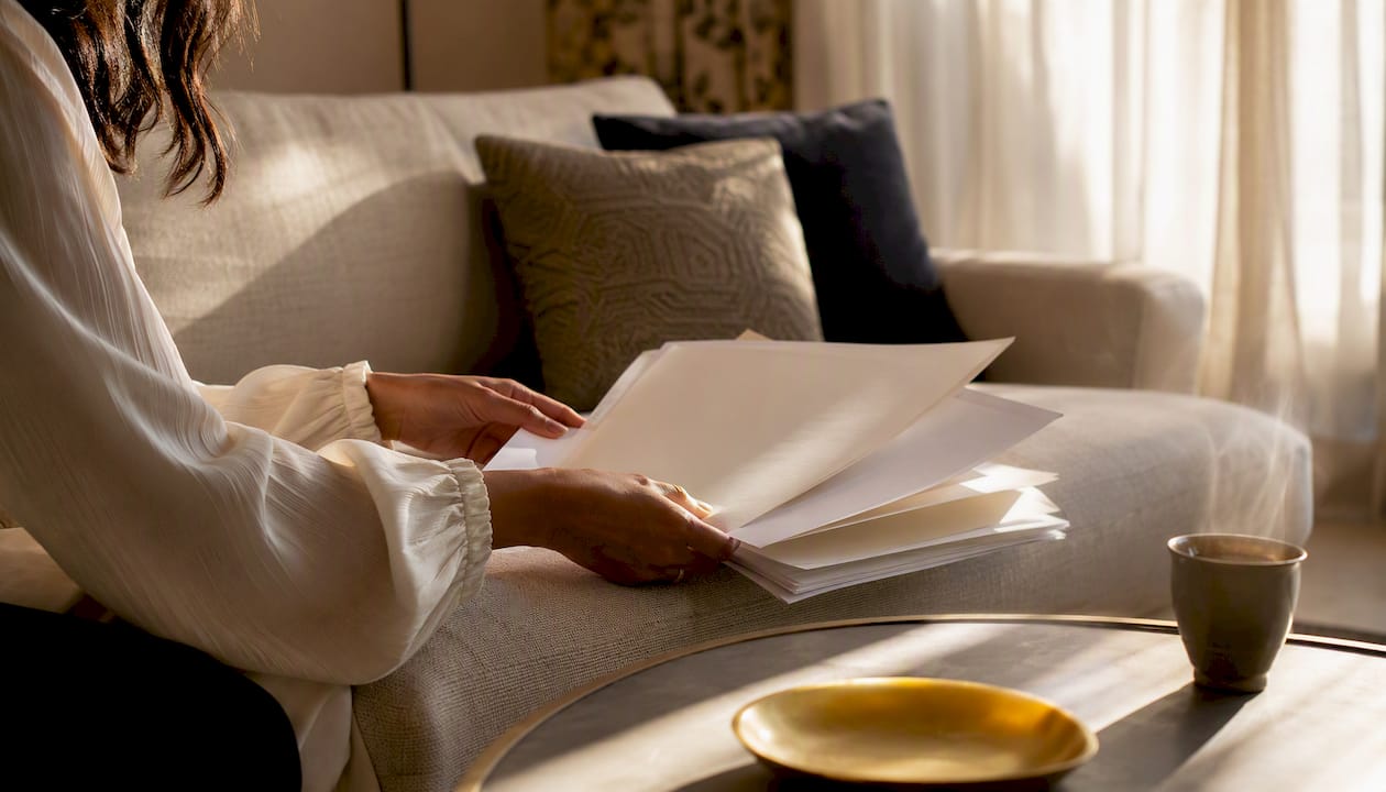 Hands arranging marriage documents on desk