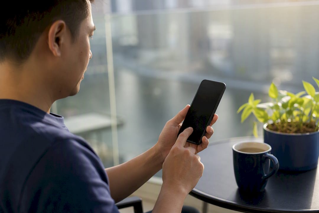 Person renewing NBI clearance on phone