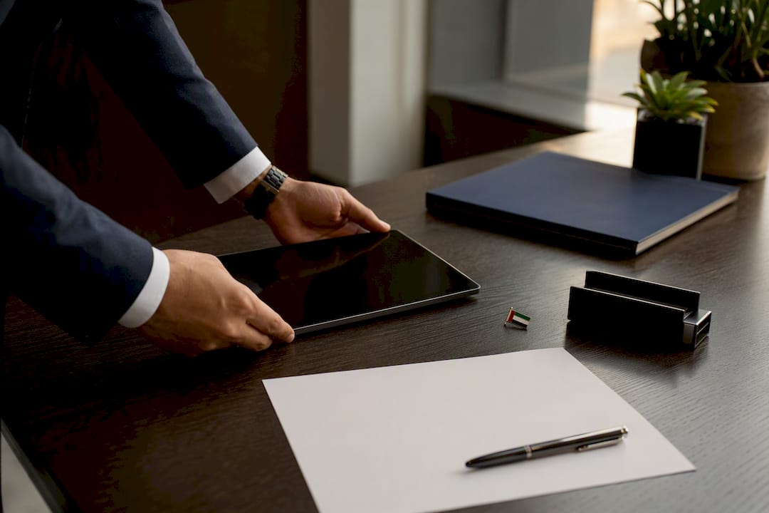 Hands arranging documents on business desk