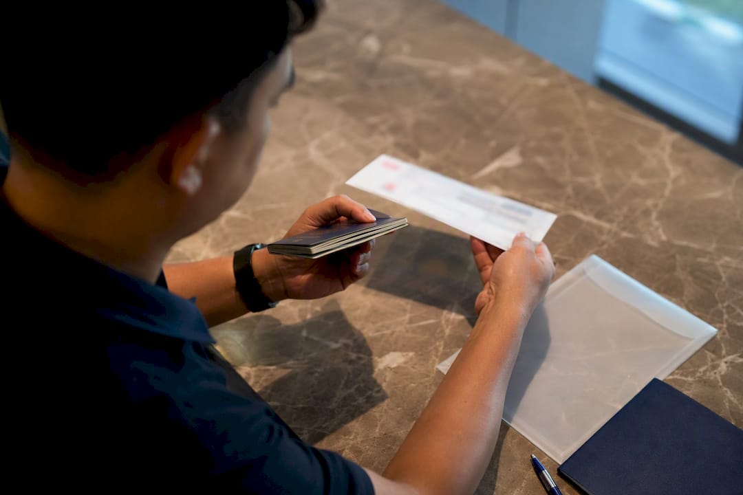 Filipino expat checking documents before courier submission