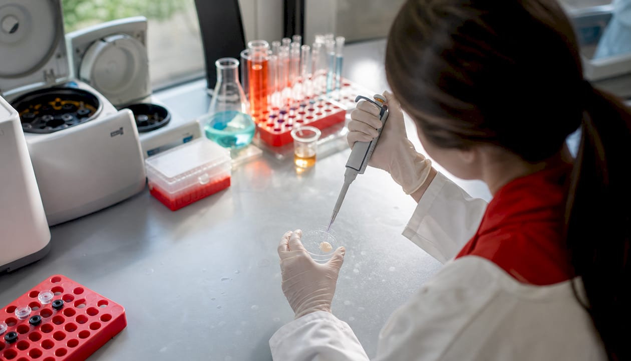 Hands testing dental ingredients in lab