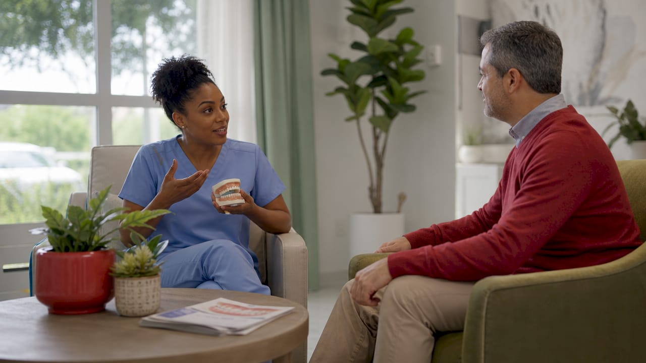 Dentist explaining oral health changes to patient