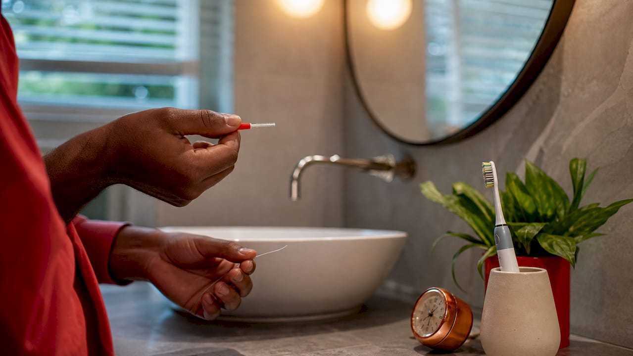 Hands holding interdental cleaning tools