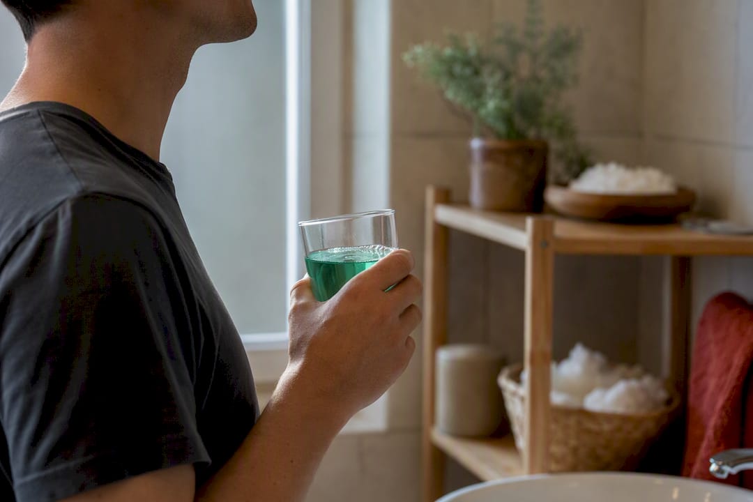 Person rinsing mouth with mouthwash