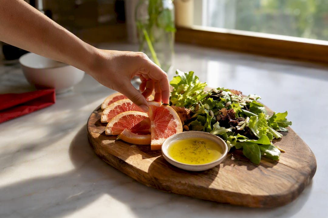 Hand picking citrus fruit during meal