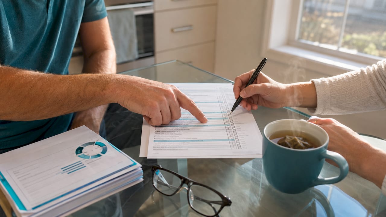 Hands reviewing borrower eligibility checklist