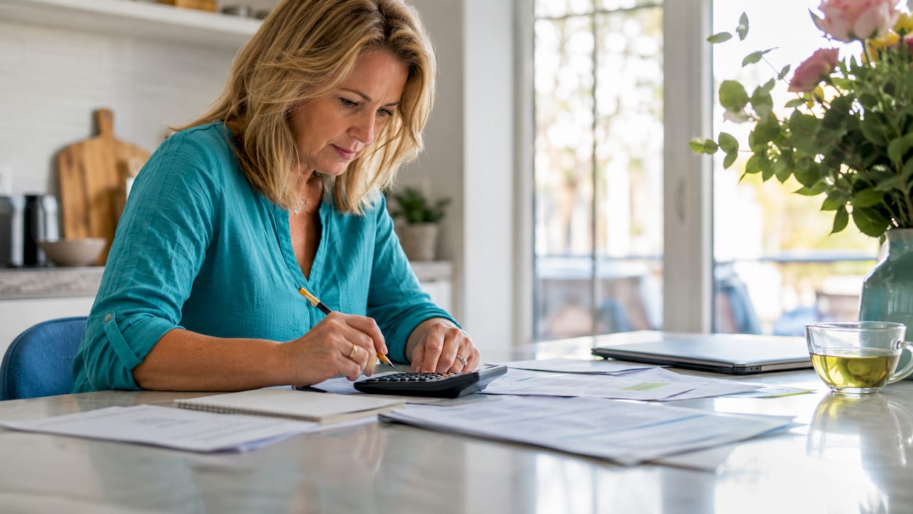 Woman calculating mortgage payments at home desk