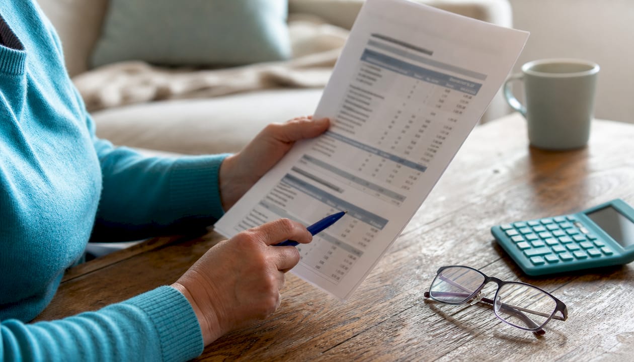 Close-up hands holding mortgage statement document