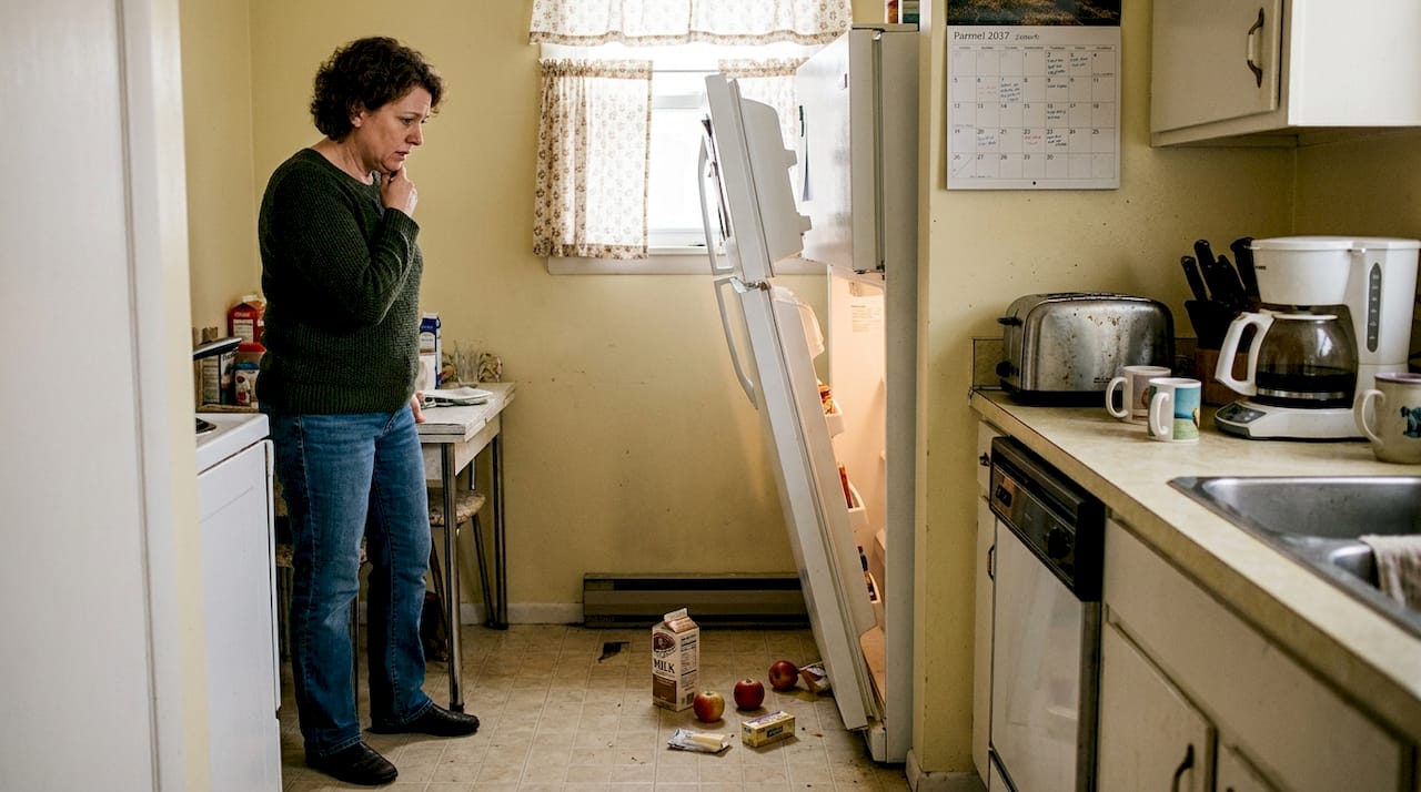 Tipped refrigerator with spill in kitchen
