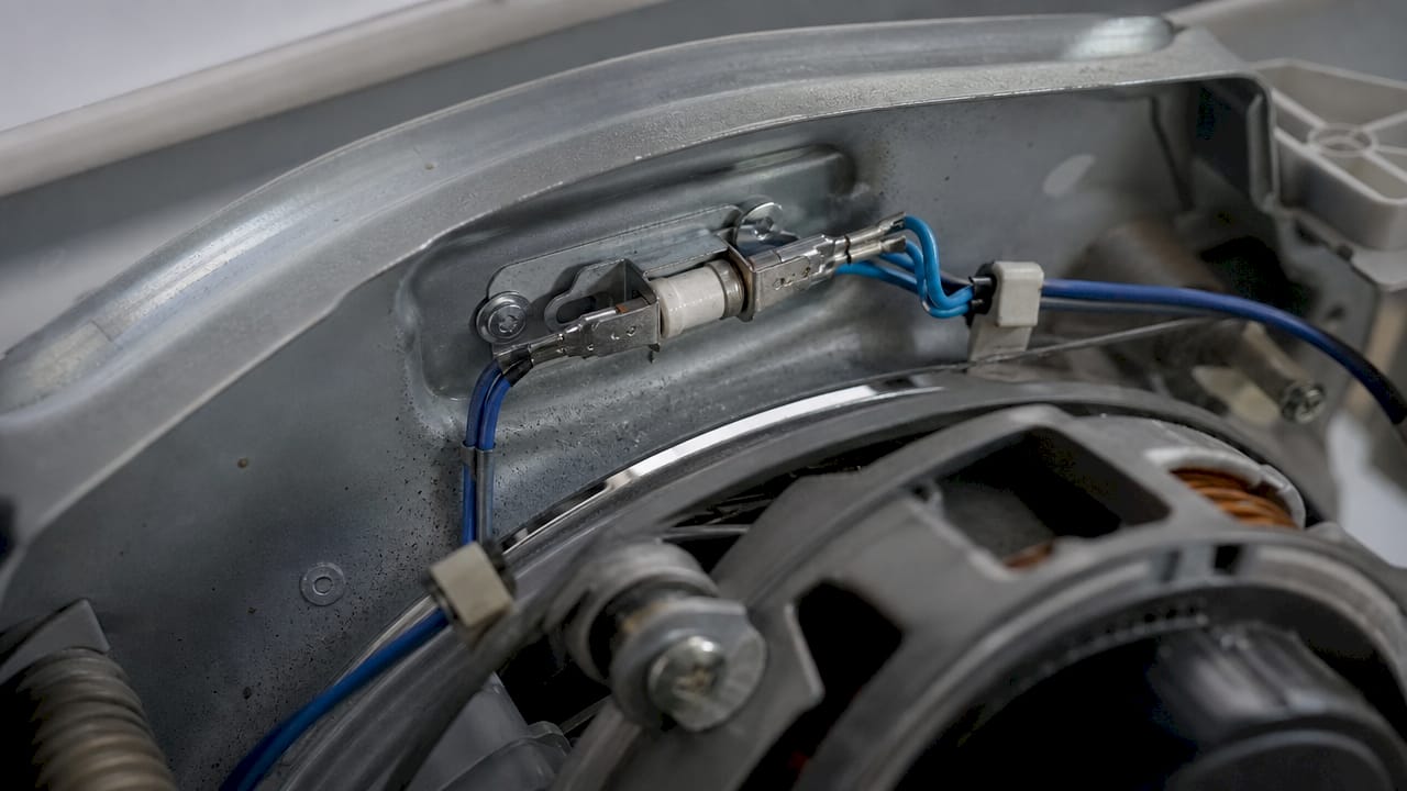 Close-up of thermal fuse inside dryer heater compartment
