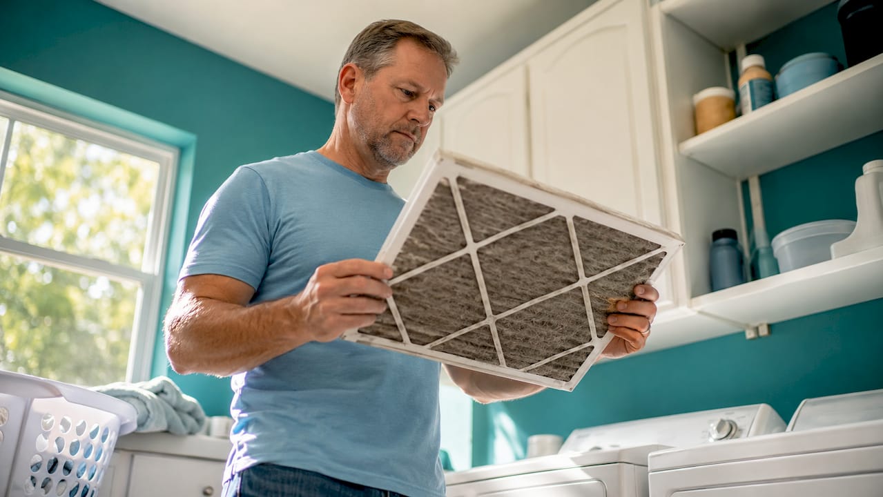 Homeowner checking HVAC air filter
