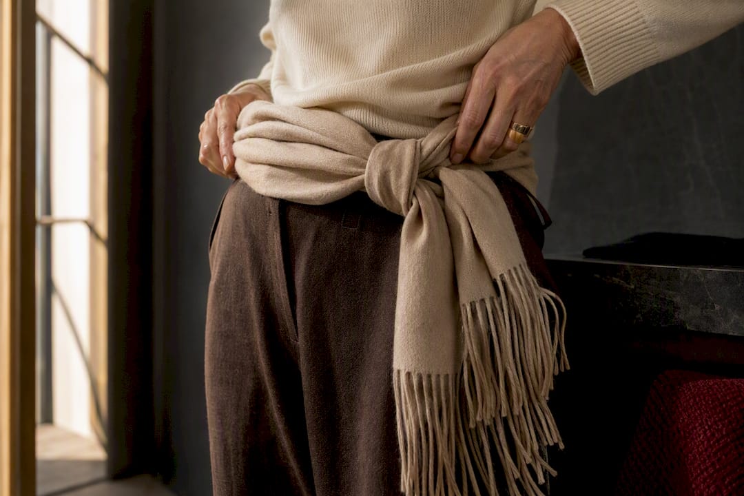 Fringed scarf knotted as a belt