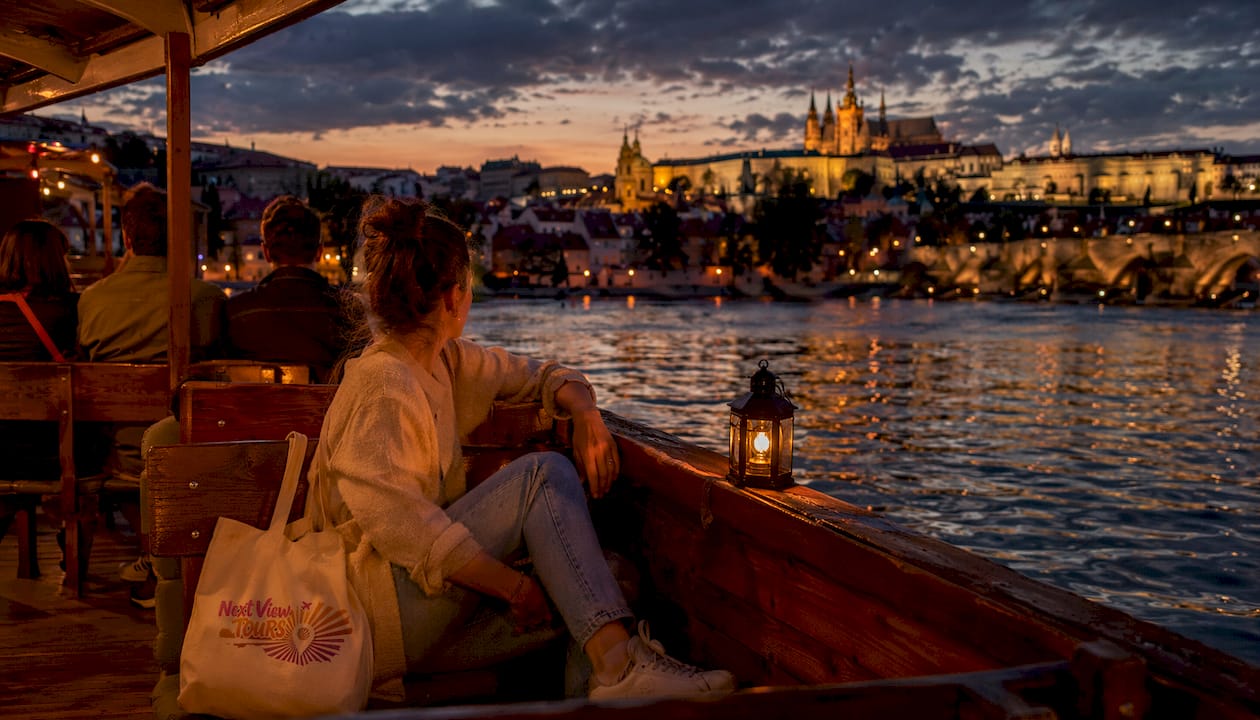 Tourist on river cruise at dusk in Prague