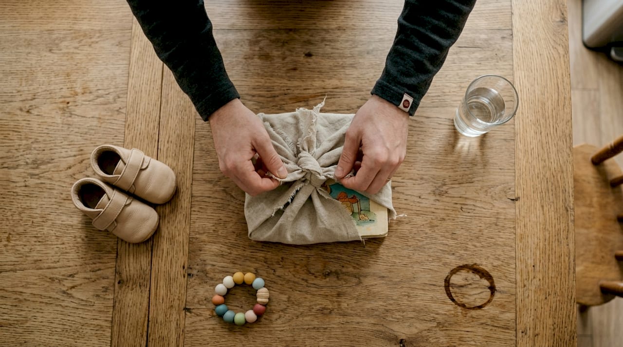 Hands tying furoshiki textile wrap
