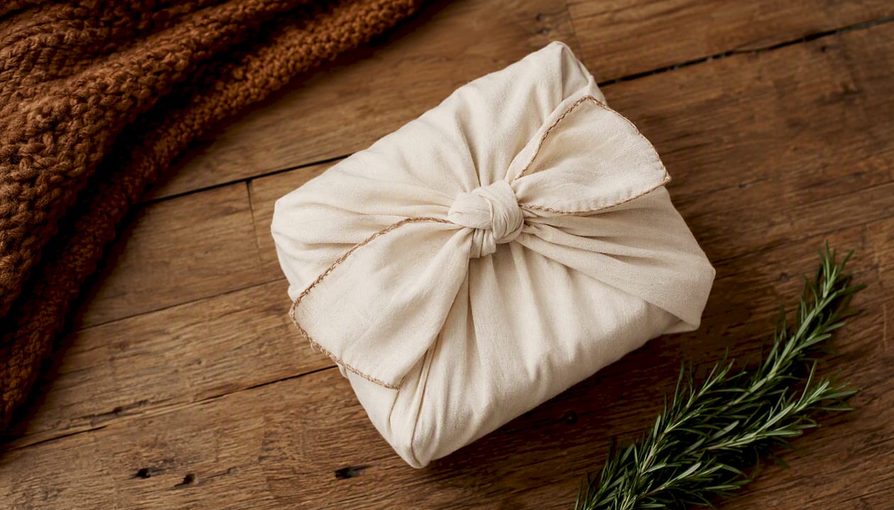 Newborn gift wrapped in personalised fabric wrap