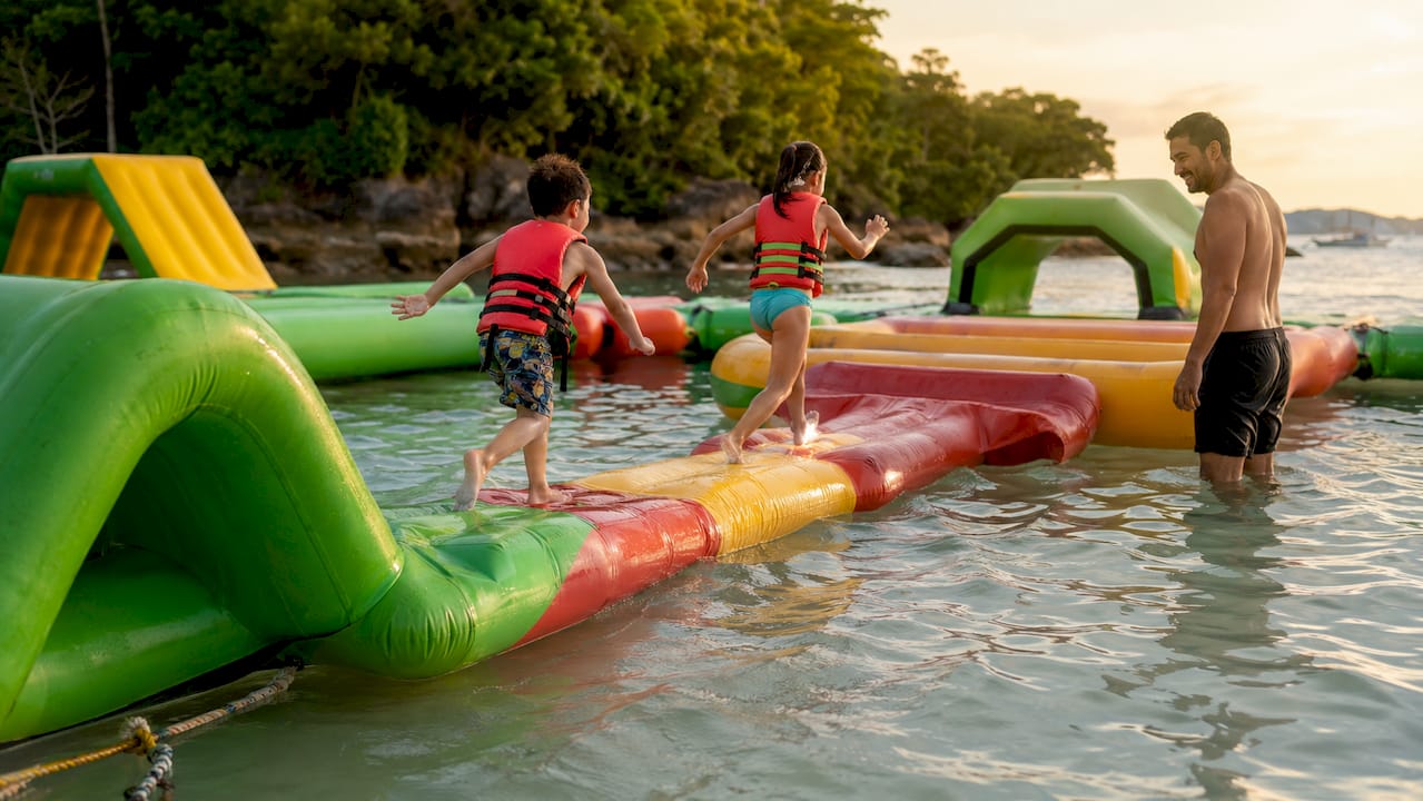 Modular inflatable water playground with people playing