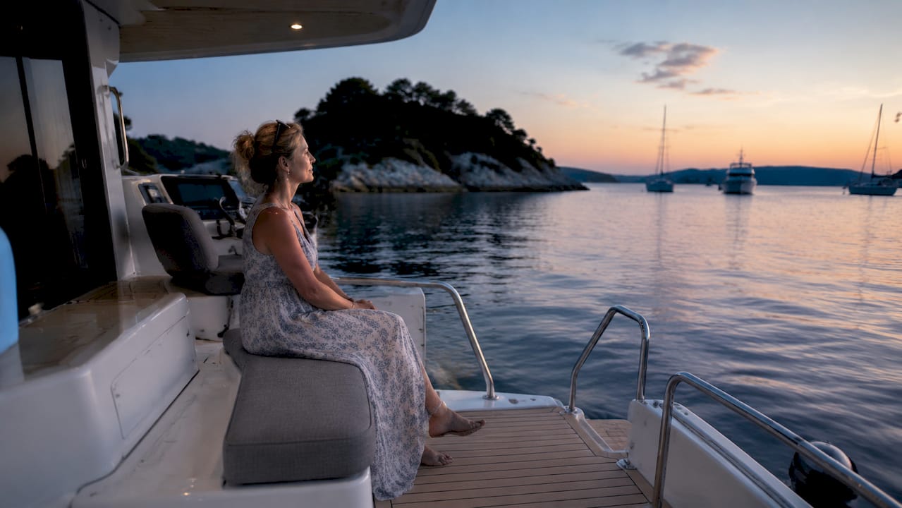 Captain enjoying quiet hybrid yacht at marina