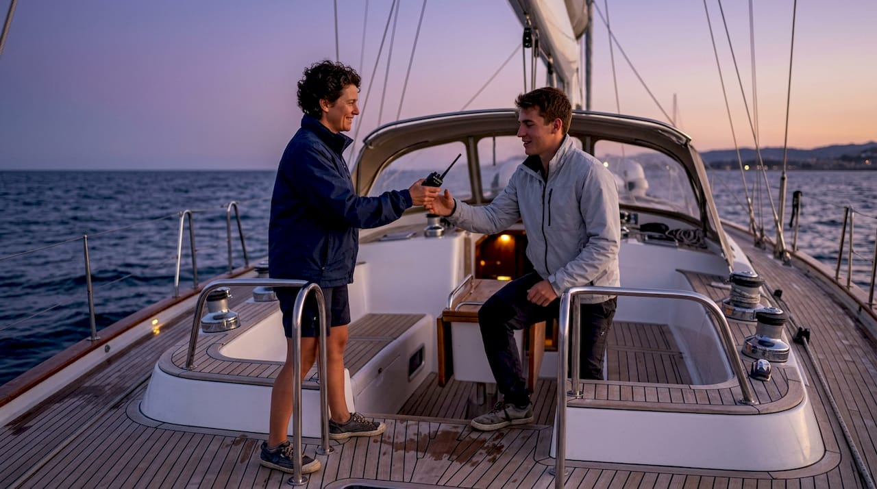 Crew members exchanging watch duties aboard yacht
