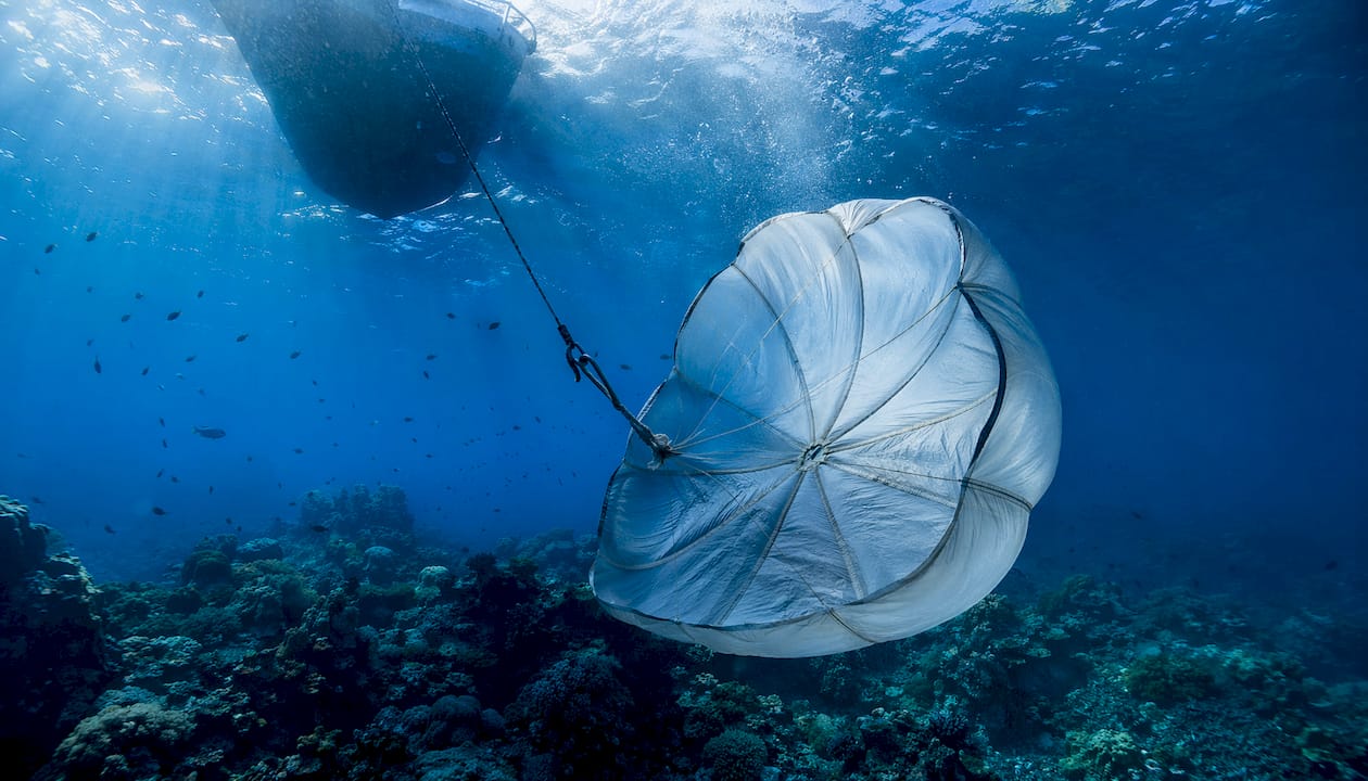 Underwater sea anchor parachute inflated beneath yacht