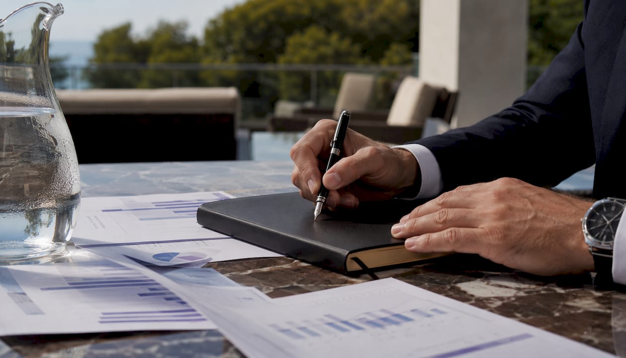 Close-up of hands reviewing market data documents