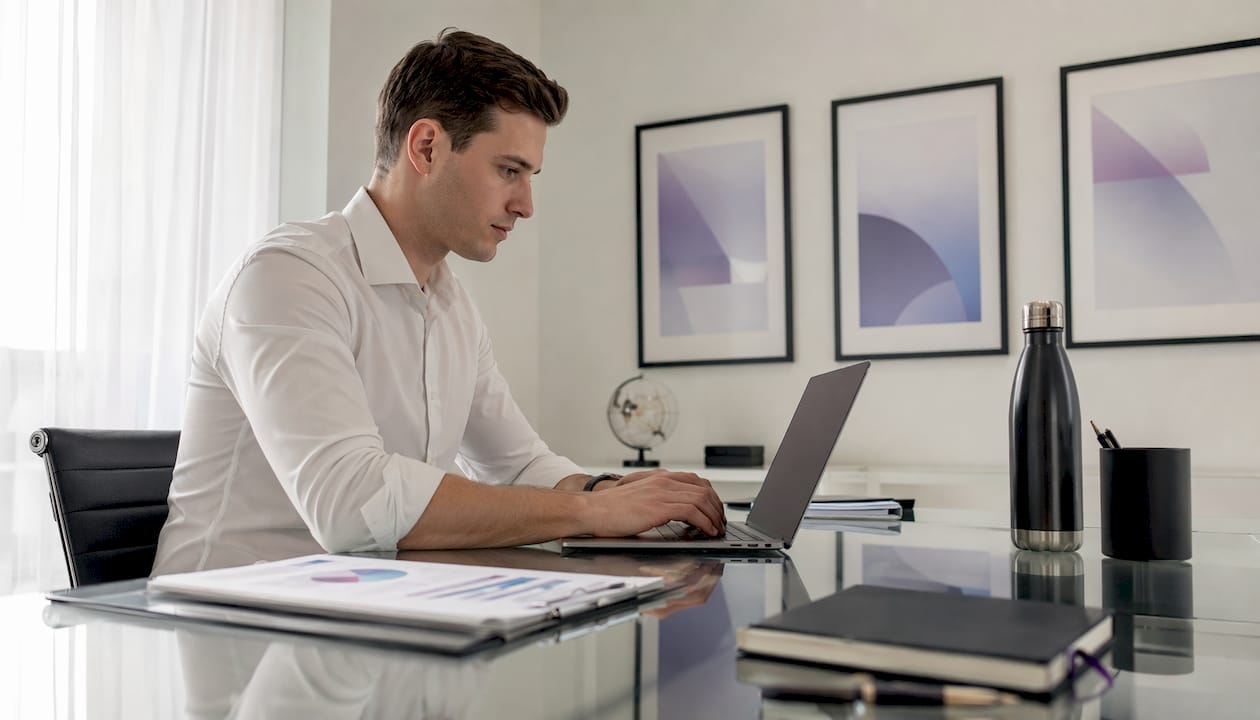 Financial analyst working on retention profitability laptop