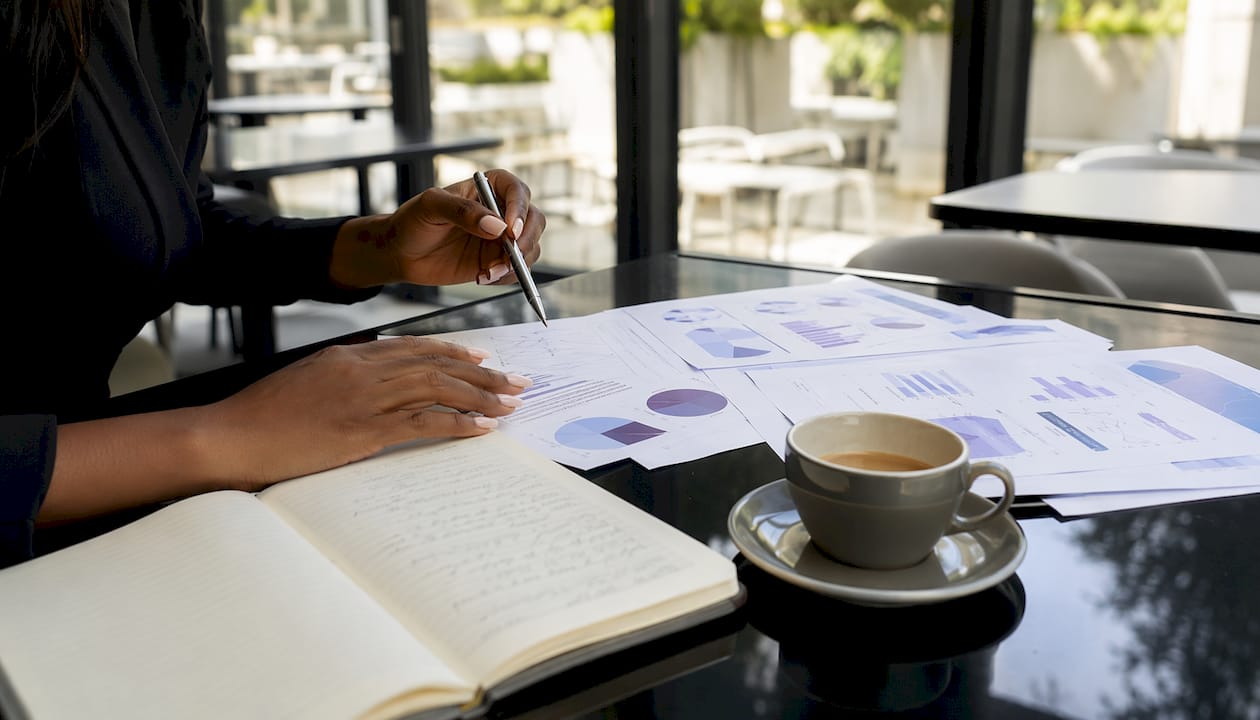 Hands analyzing client retention data and churn charts