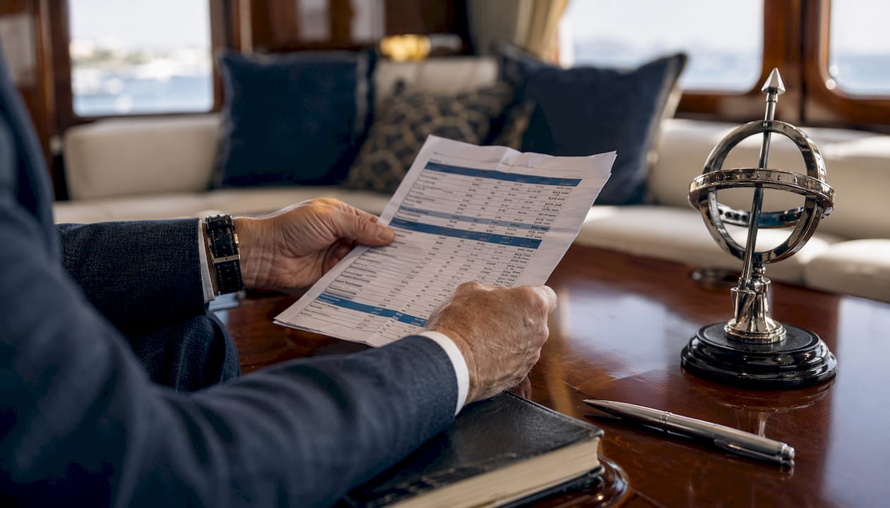 Overhead hands reviewing yacht operating cost report
