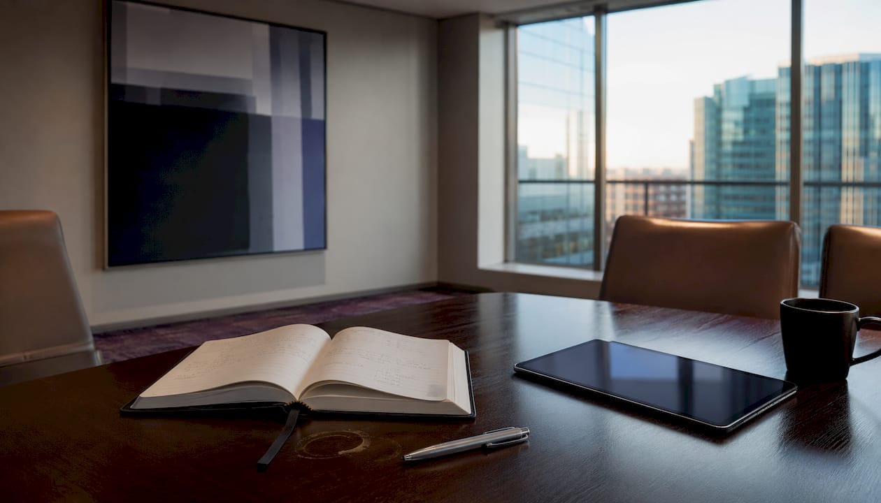 Sales meeting room table with planner and tablet