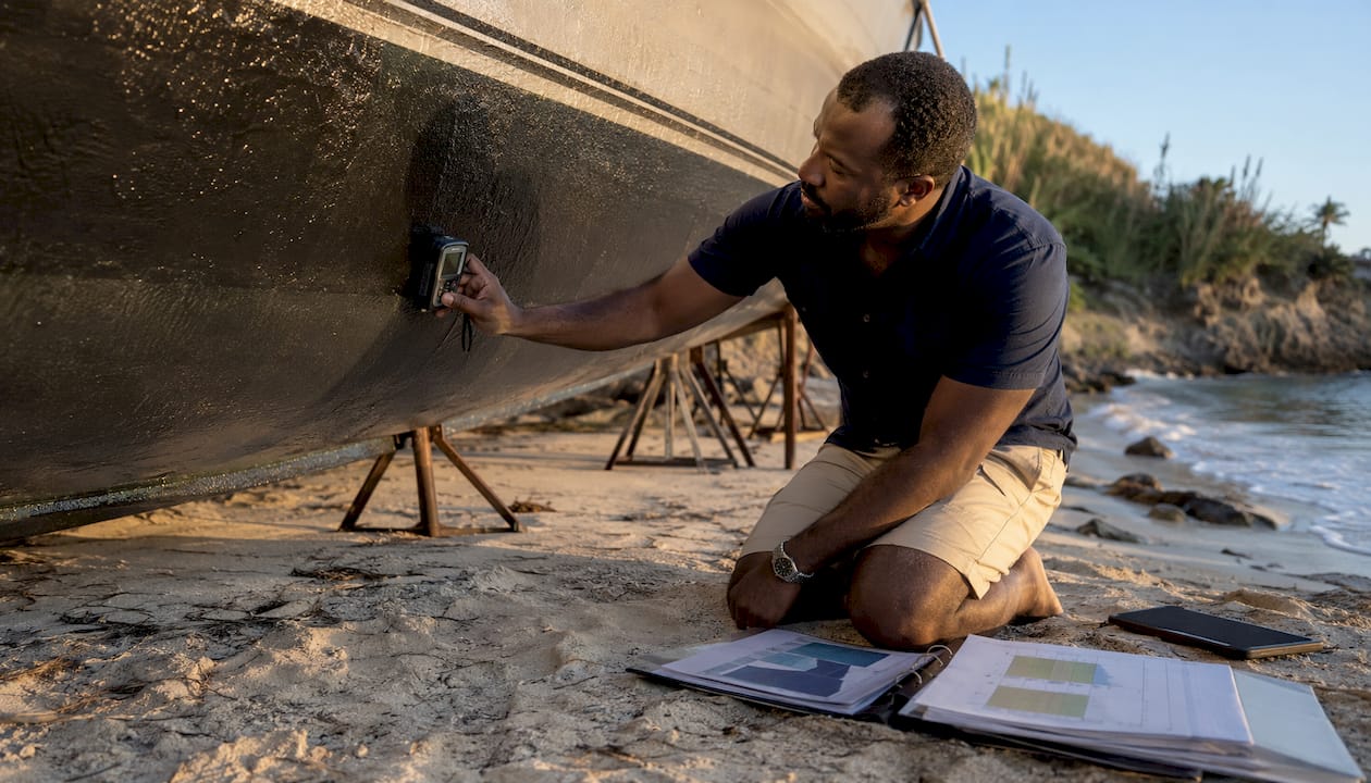 Marine surveyor inspecting yacht hull layers