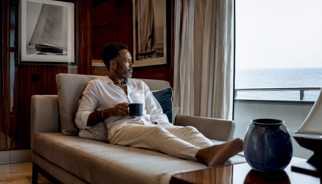 Luxurious yacht cabin with man relaxing