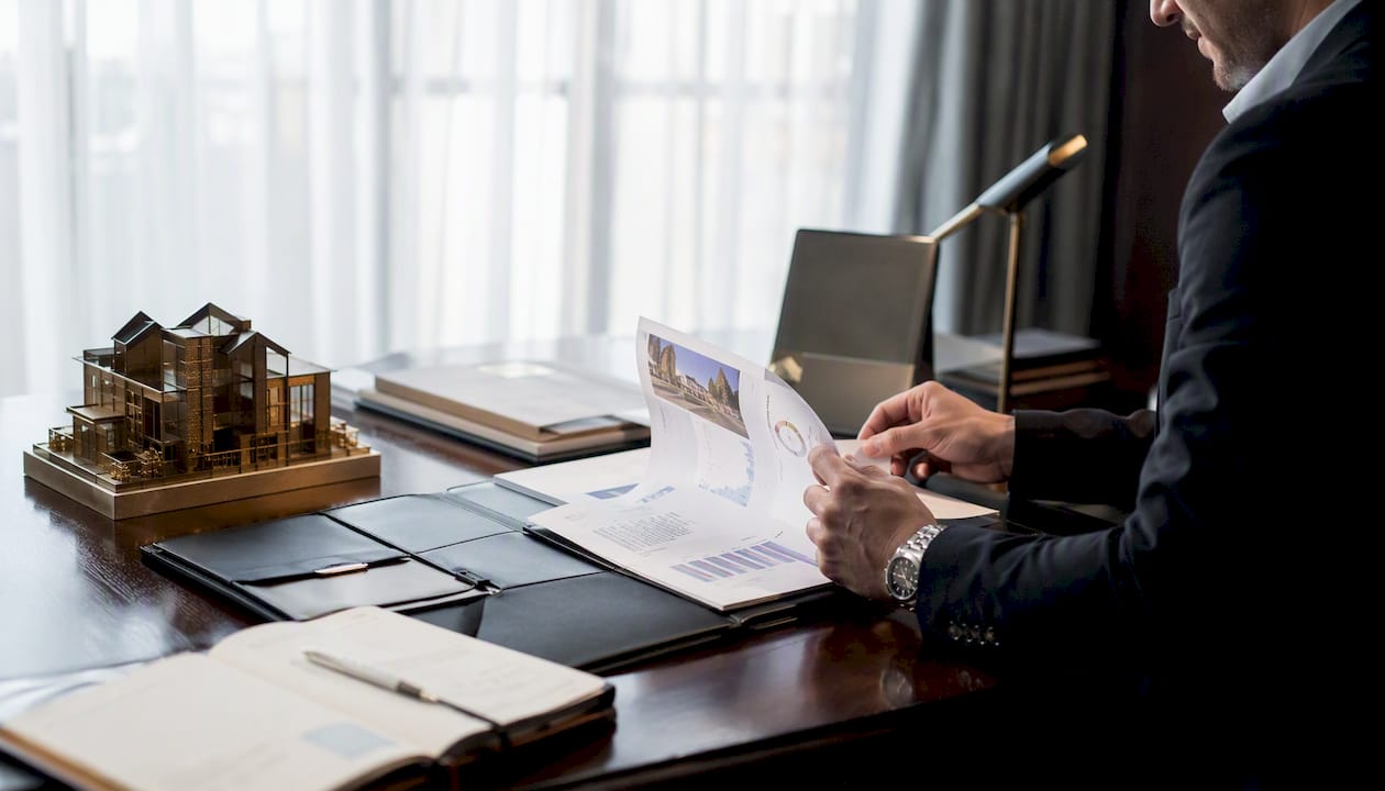 Real estate agent reviewing brochures in office