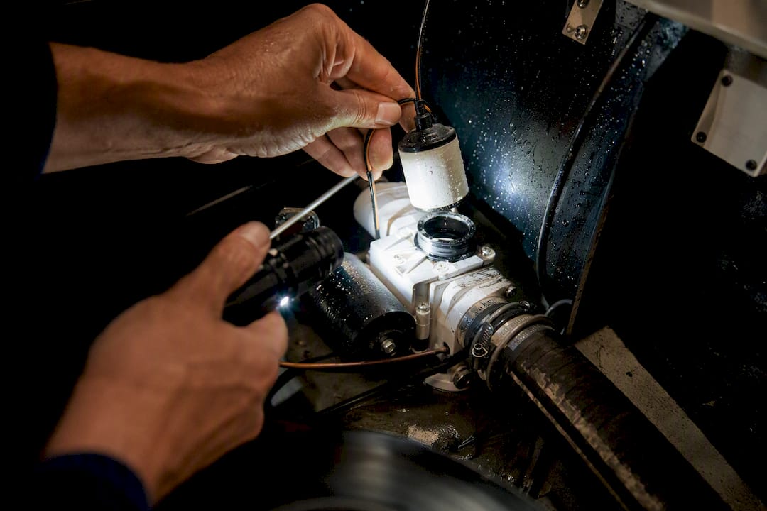 Hands testing yacht bilge pump float switch