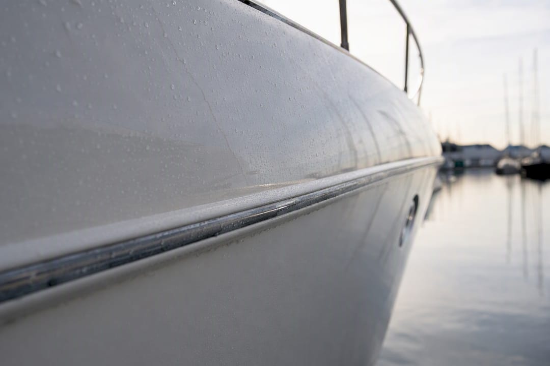 Close-up of yacht hull surface with water droplets