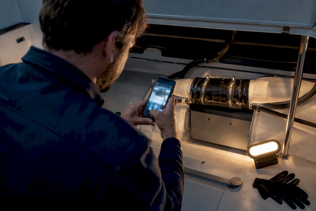 Technician documenting completed yacht repair