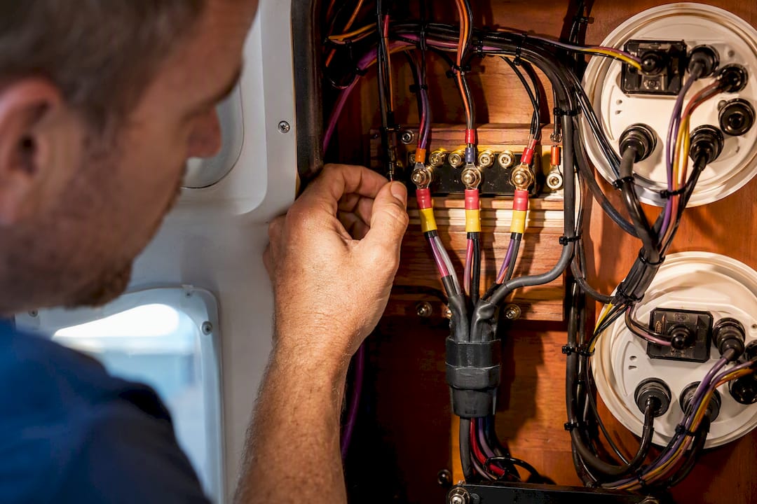 Technician tracing dual station sender wiring