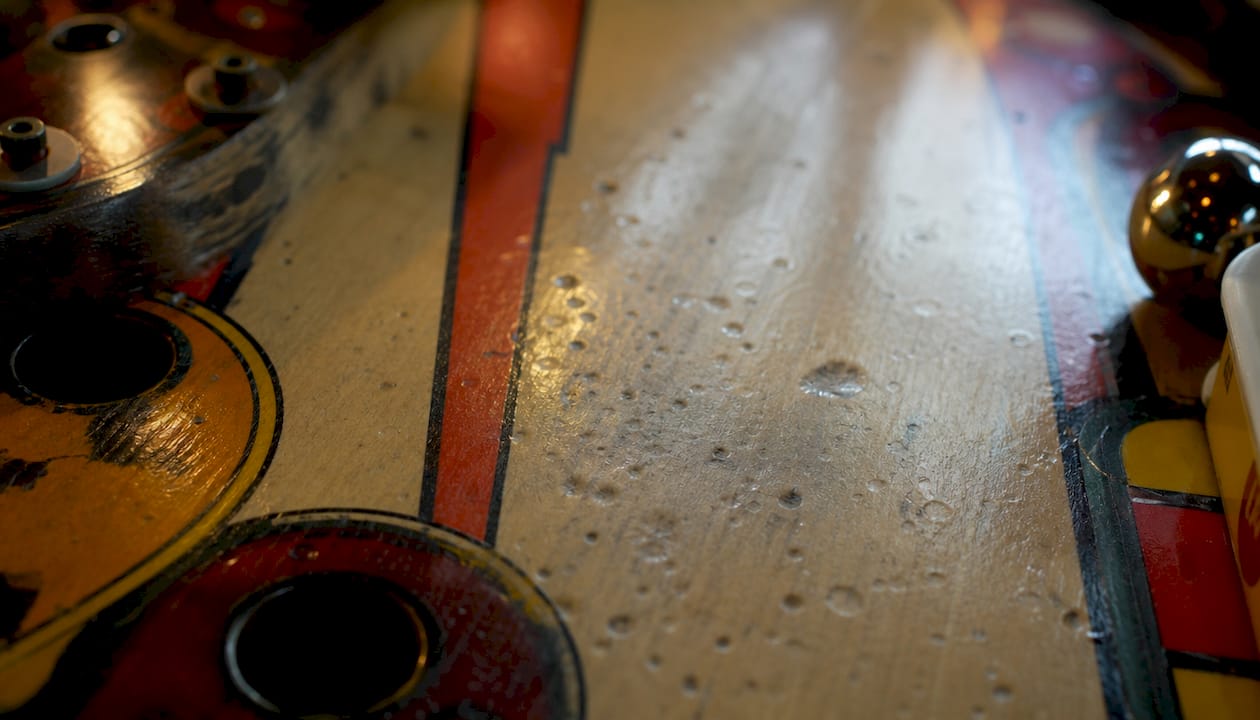 Close-up of worn pinball playfield surface