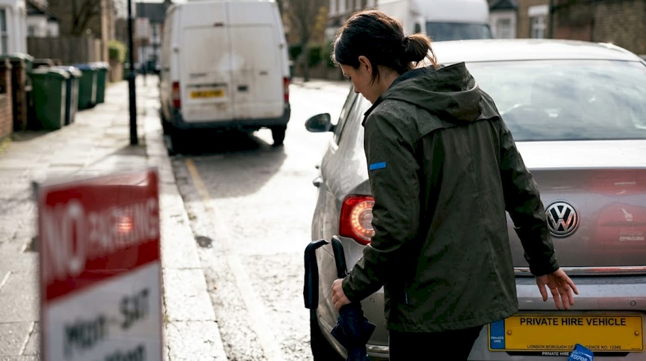 Passenger checking council licence plate on car