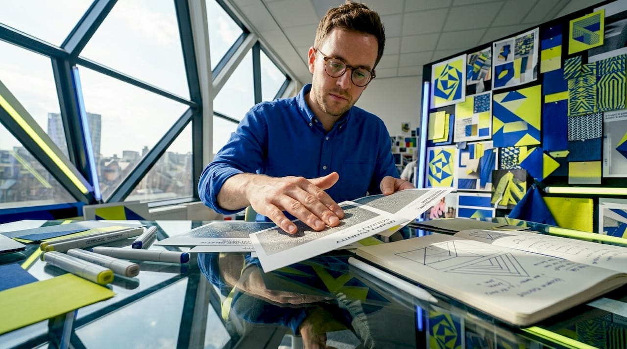 Designer evaluating textured tactile print samples