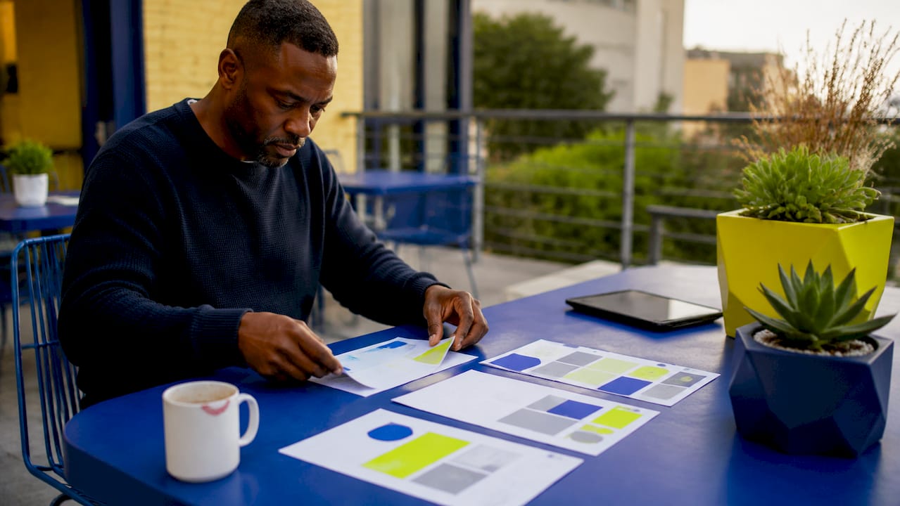 Hands sorting landing page elements overhead