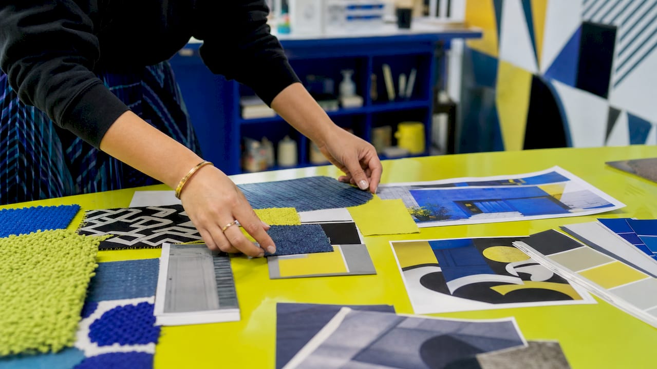 What is a mood board? Your guide to visual direction 1 Hands pinning visual elements on mood board