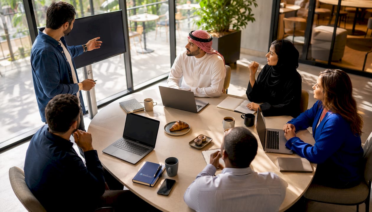 Sales team discussing CRM requirements in meeting room